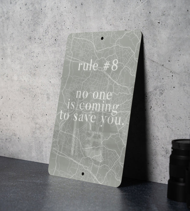 a sign on a table that says rules 8 no one is coming to save you
