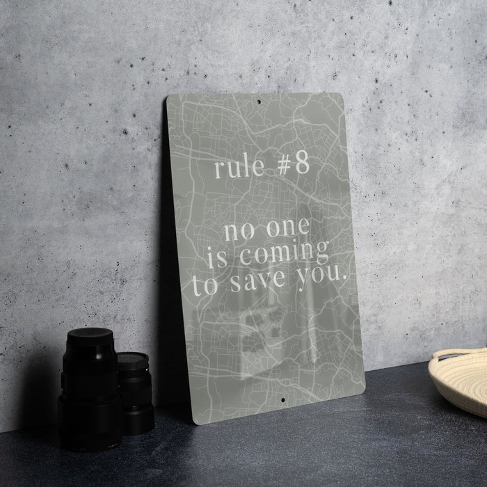 a sign that says, rules 8 no one is coming to save you