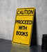 a yellow caution sign sitting on top of a table