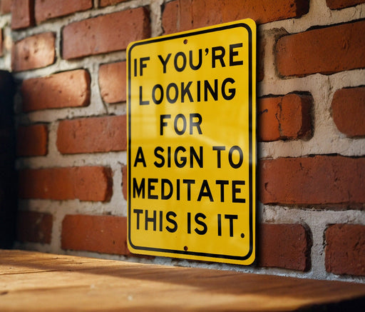 a yellow sign on a brick wall saying if you're looking for a sign