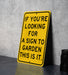 a yellow sign that says if you're looking for a sign to garden this