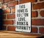 a sign on a brick wall that says this home is built on love books and