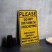 a yellow do not disturb i'm crocheting sign next to a white