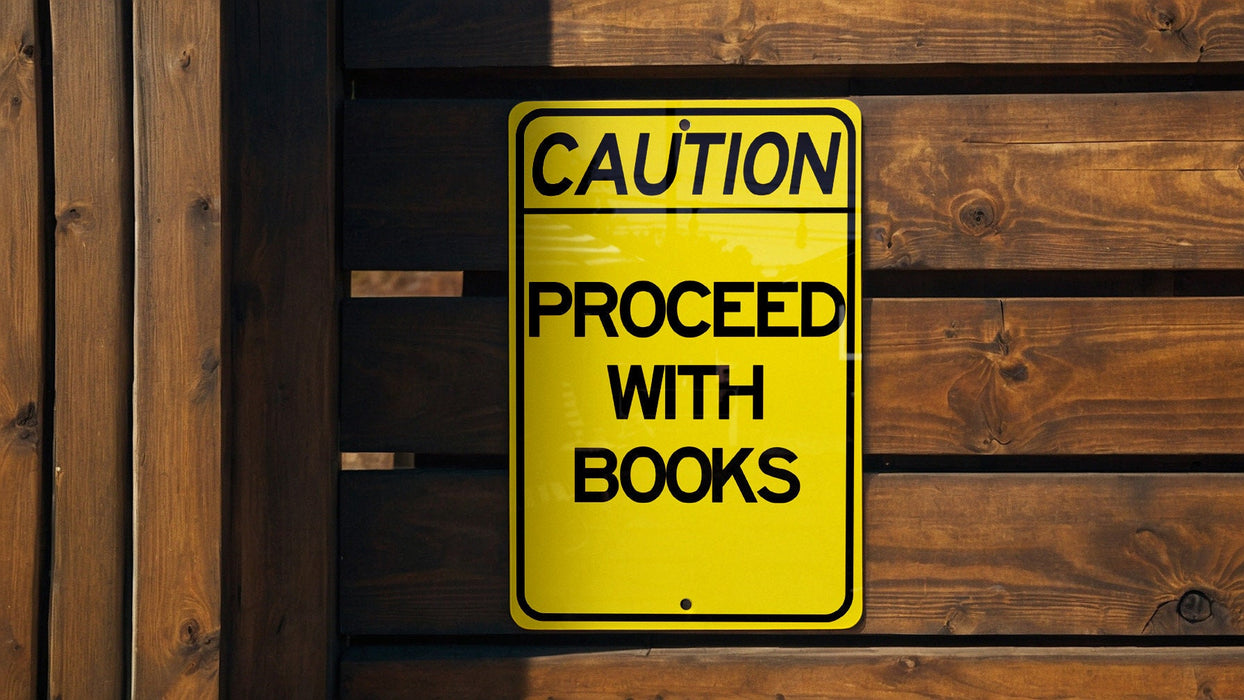 a caution sign posted on a wooden fence