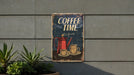 a sign on the side of a building that says coffee time