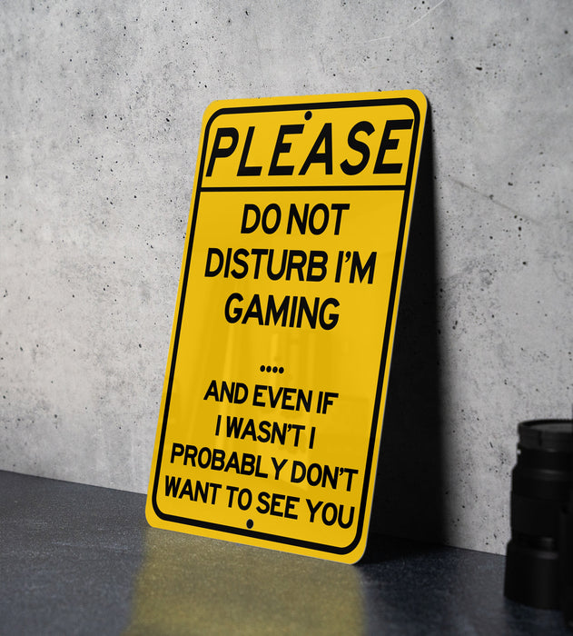 a yellow sign that says please don't disturb i'm gaming and even