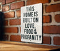 a sign on a brick wall that says this home is built on love food and