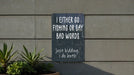 a sign on the side of a building that says i either go fishing or say