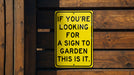 a yellow sign that says if you're looking for a sign to garden this