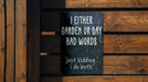 a sign on a wooden fence that says i either garden or say bad words