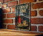 a coffee time sign on a brick wall