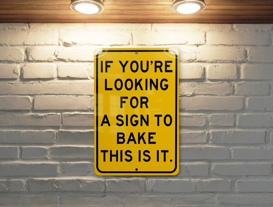 a yellow sign that says if you're looking for a sign to bake