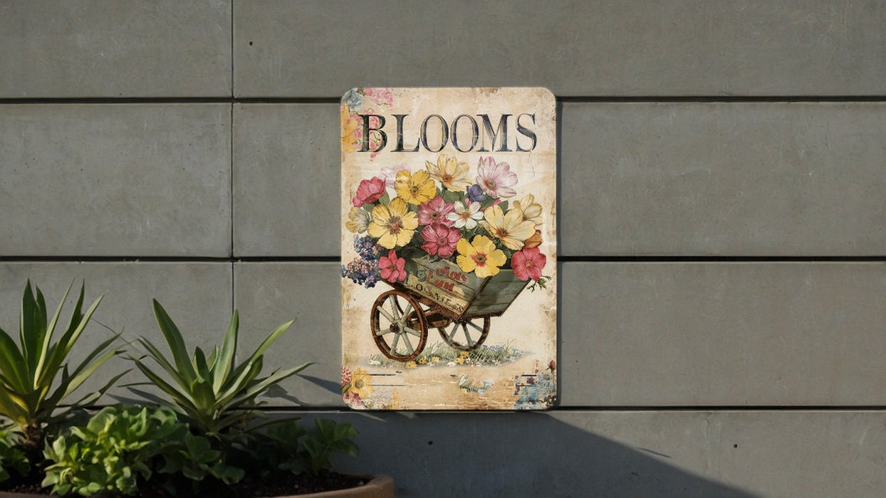 a sign on a wall with a wheelbarrow full of flowers