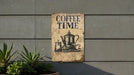 a coffee time sign on the side of a building