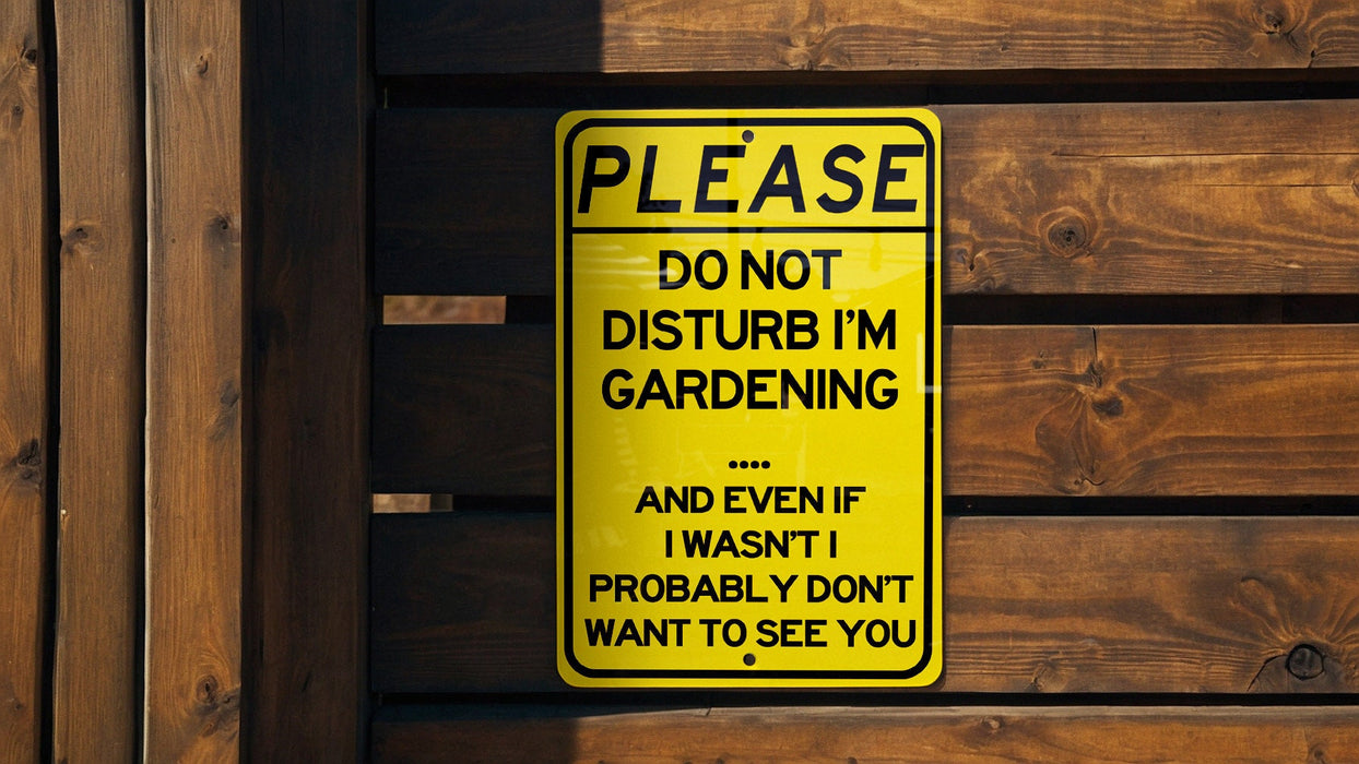 a do not disturb im gardening sign on a wooden fence