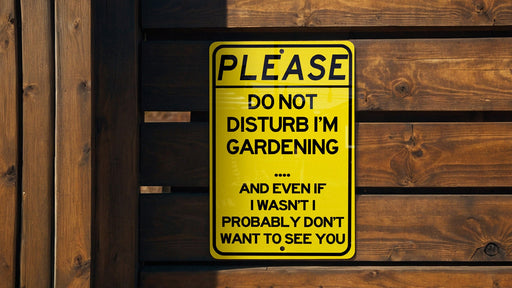 a do not disturb im gardening sign on a wooden fence