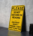 a yellow sign sitting on top of a table