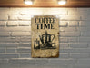 a coffee time sign on a brick wall