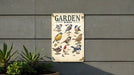 a garden book sitting on the side of a building