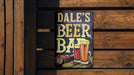 a sign that says dale's beer bar on a wooden wall