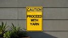 a caution sign posted on the side of a building