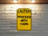 a yellow caution sign on a brick wall