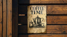 a coffee time sign hanging on a wooden wall