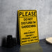 a yellow sign sitting on top of a table