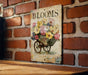 a picture of a flower cart on a brick wall