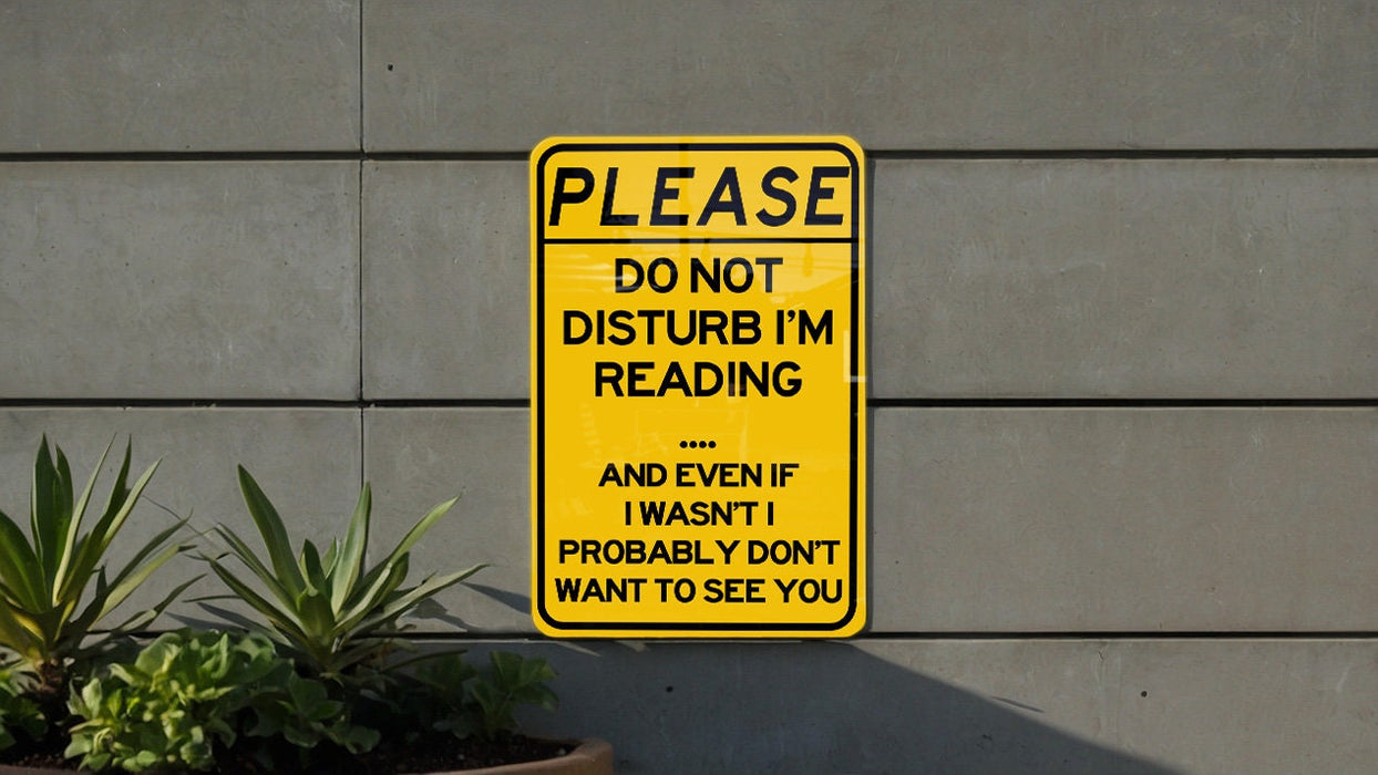 a yellow sign that says please don't disturb i'm reading