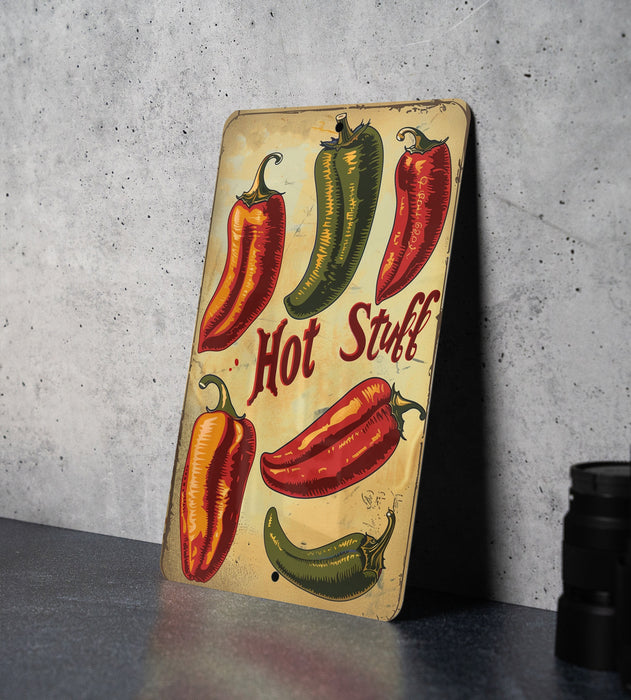 a wooden sign with hot peppers painted on it