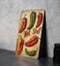 a wooden sign with hot peppers painted on it