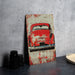 a picture of an old red car on a table