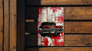 a painting of a red car on a wooden wall