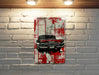 a painting of a red car on a brick wall