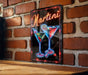 a neon martini sign on a brick wall