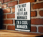 a sign on a brick wall that says i'm not like a regular manager