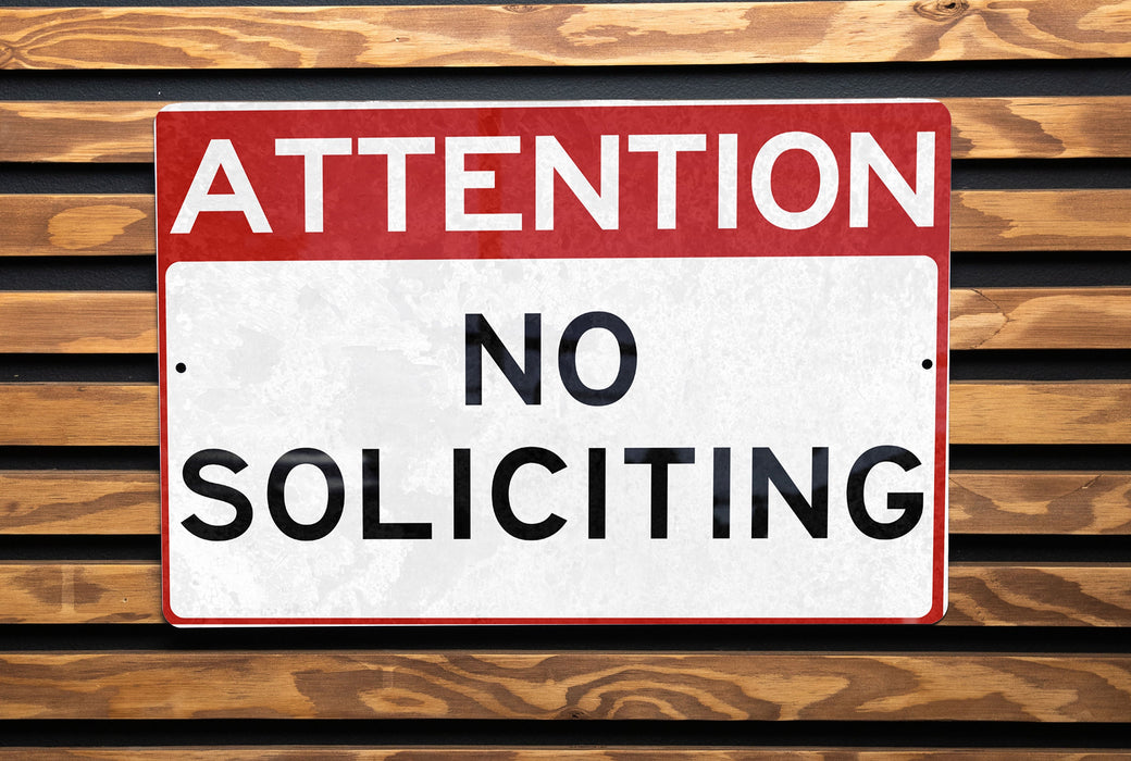 a street sign on a wooden bench in a park