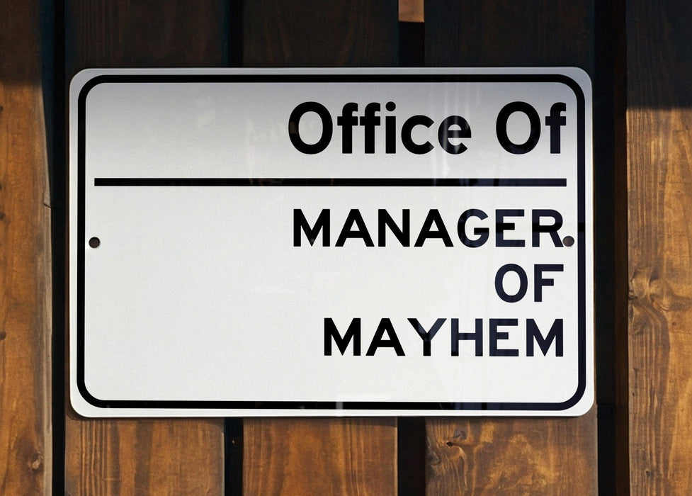 a white and black sign on a wooden fence