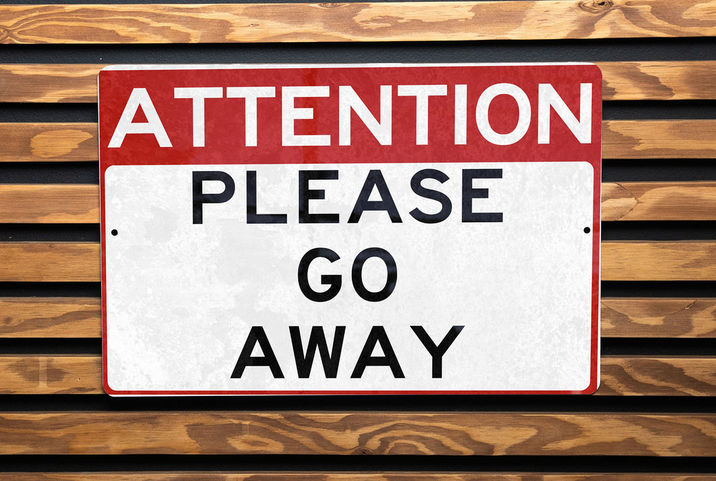a red and white street sign on a wooden wall
