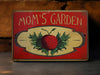 a red sign that says mom's garden on it