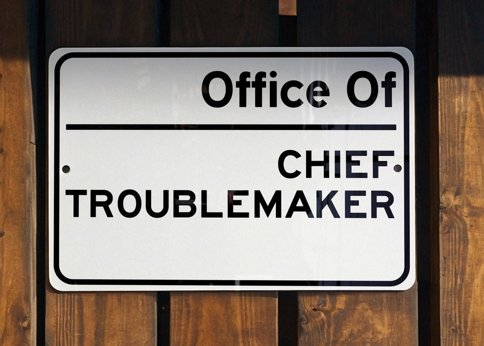 a white sign on a wooden fence that says,