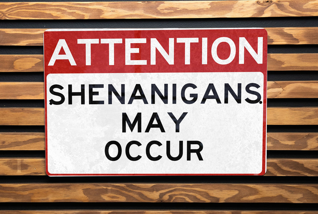 a red and white street sign sitting on top of a wooden bench