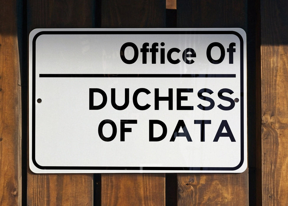 a white sign hanging on a wooden fence