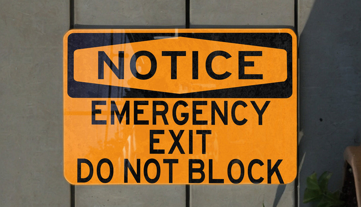 a do not block exit sign hanging on a wall