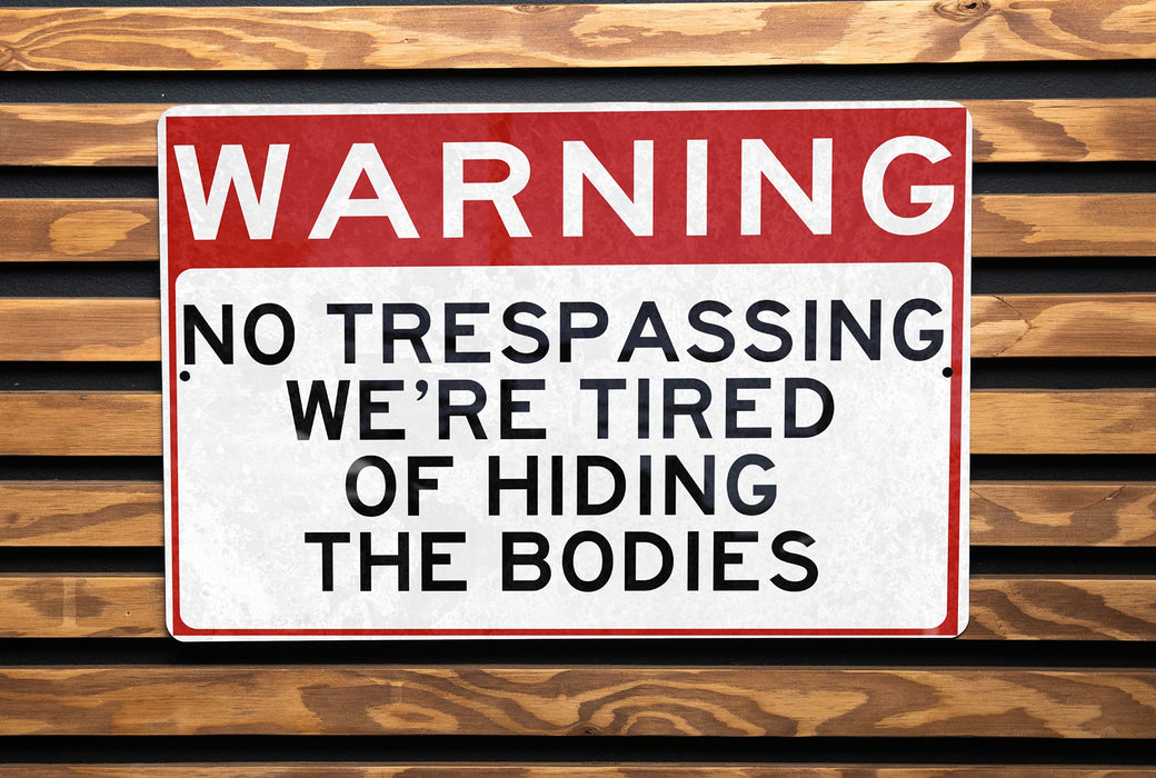 a red and white sign on a wooden bench