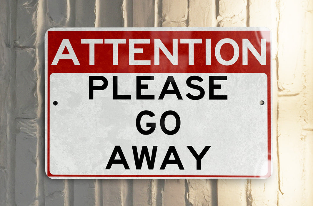 a red and white street sign hanging from the side of a building