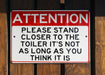 a red and white sign on a wooden fence