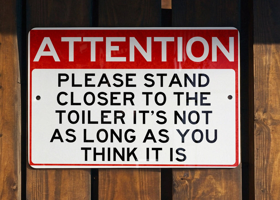 a red and white sign on a wooden fence