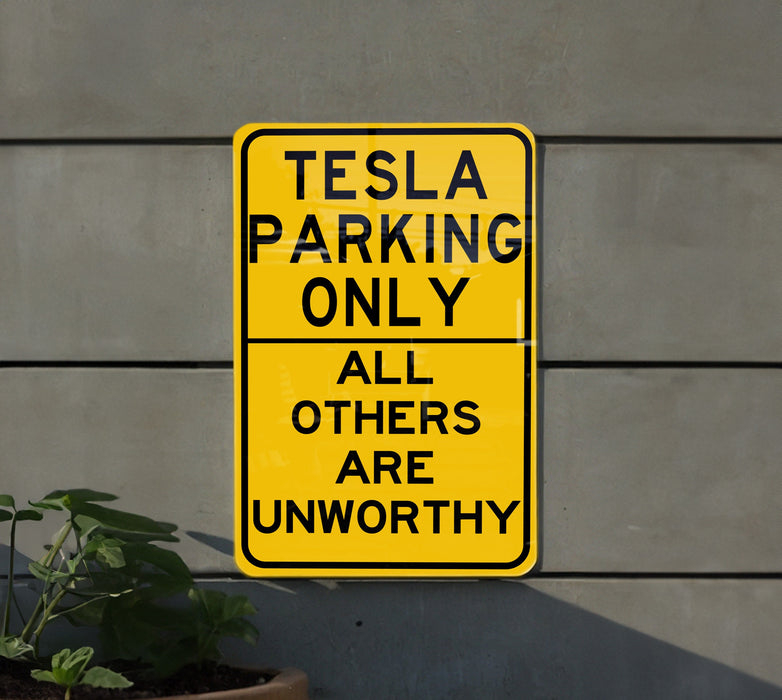 a yellow sign that says tesla parking only all others are unworthyly